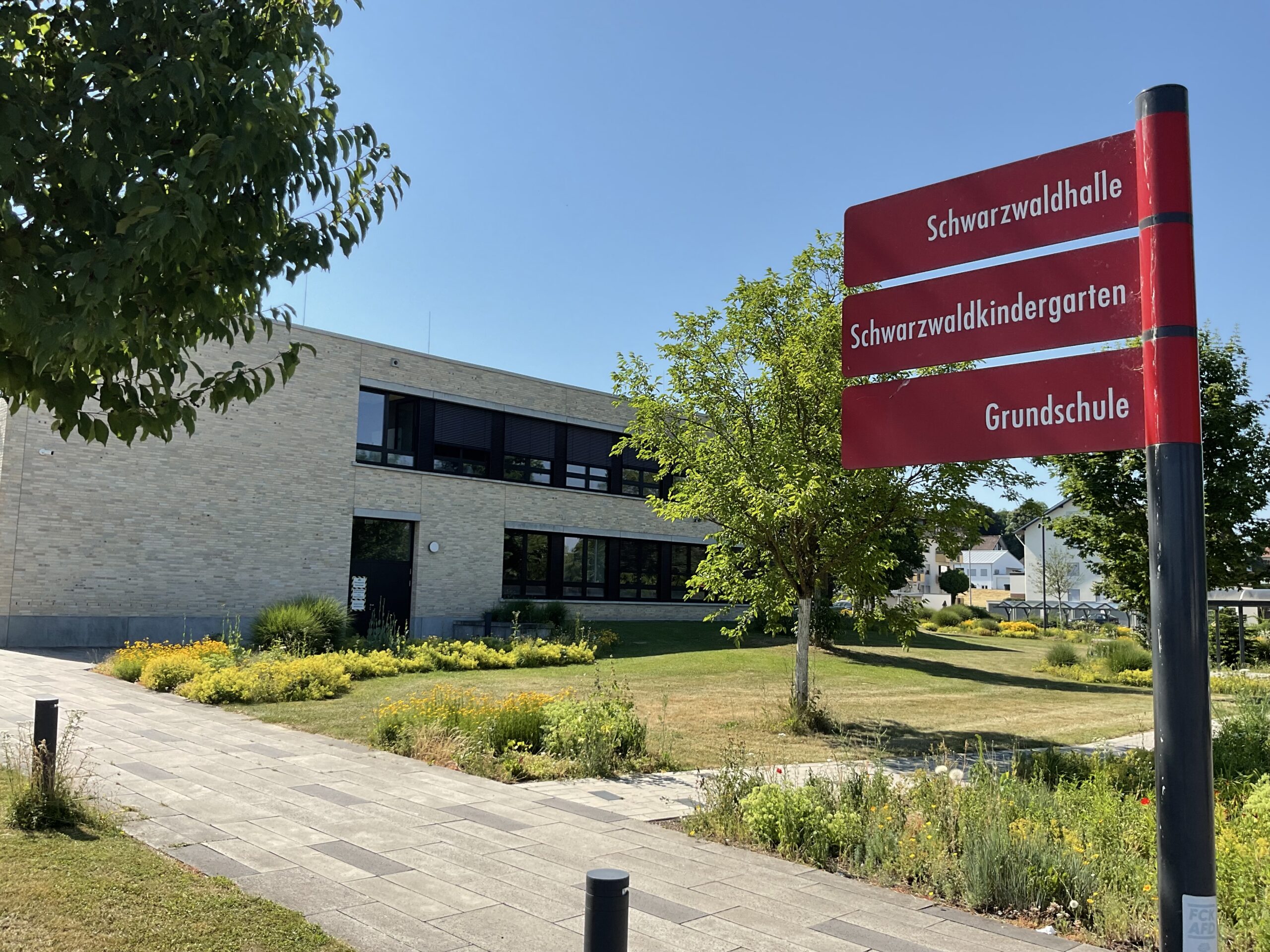Gebäude der Schwarzwaldschule mit Wegschild im Vordergrund.
